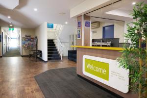 a lobby with a welcome counter in a store at ibis Budget Perth Airport in Perth