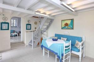 a dining room with a blue table and a staircase at Villa Potami in Agnontas
