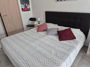 a bedroom with a bed with two pillows on it at Les Lauriers in Espondeilhan +13 photos