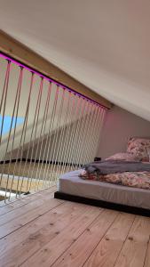 a bedroom with a bed and a large window at Gleisbett 12-3 in Meiningen