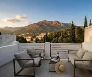 a balcony with couches and a view of a mountain at Villa Kipre in Cavtat
