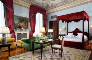 a bedroom with a canopy bed and a desk and a bed at Villa Cora in Florence +48 photos