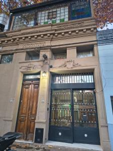 a building with two sets of doors on a street at Hospedaje La Trinidad in Junín