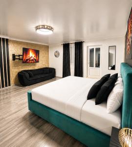 a bedroom with a large bed and a fireplace at Luxor - Private Jacuzzi Boulevard Suites in Sibiu
