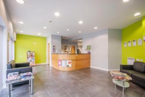 a waiting room with yellow and green walls at Beaverbank Place - Campus Residence in Edinburgh