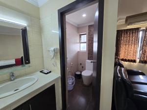 a bathroom with a sink and a toilet at Hotel Ashok Residency, Porur in Chennai