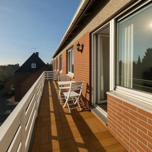 a balcony with two benches on the side of a house at Pulheim Living 6 in Pulheim