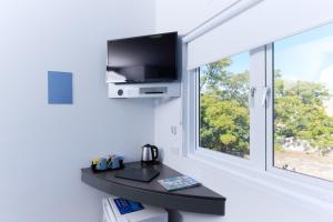 a living room with a tv and a window at ibis Budget Perth Airport in Perth