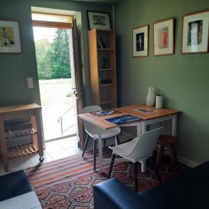 a dining room with a table and chairs and a window at Chambre d'hôte Le Châtaignier in Planchez +27 photos