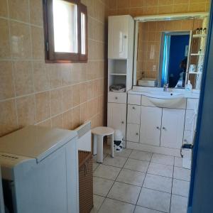 a small bathroom with a sink and a mirror at Chambre d'hôte Le Châtaignier in Planchez