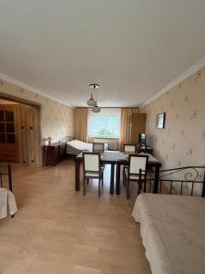 a room with a table and chairs and a bedroom at Zakątek in Porąbka
