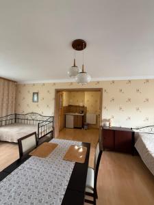 a bedroom with two beds and a dining table in it at Zakątek in Porąbka