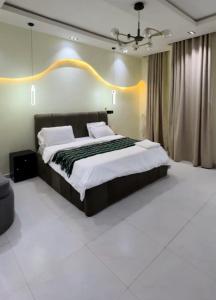 a bedroom with a large bed in a room at De Rich Residence Apartment in Benin City