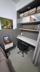 an office with a desk and a chair in a room at Quarto Vista Mar in Recife