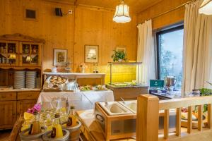a kitchen with wooden walls and a table with food on it at Hotel Brunner in Amberg