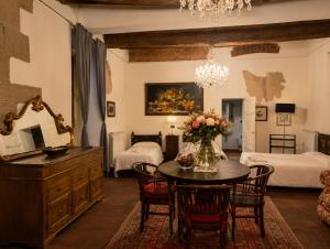 a living room with a table and a bedroom at Le Dimore della Seta - Palazzo Busdraghi in Lucca