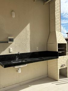 a bathroom with a sink on the side of a building at Sorte e Amaro in Santo Amaro +18 photos