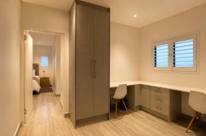 a bedroom with a desk and a window at Yzer4You in Yzerfontein +32 photos