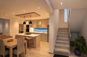 a kitchen and dining room with a staircase in a house at Yzer4You in Yzerfontein