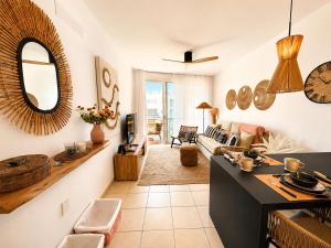 a kitchen and living room with a couch and a table at Ocean View in Puerto de Santiago