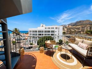 a balcony with a couch and a view of the ocean at Ocean View in Puerto de Santiago
