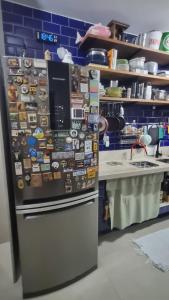 a refrigerator with magnets on it in a kitchen at Quarto Vista Mar in Recife