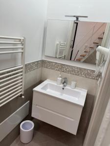 a bathroom with a white sink and a mirror at Bukowski Loft House in Porticello +15 photos
