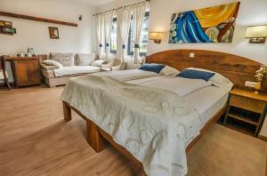 a bedroom with a large bed and a living room at Green Garden Plitvice lakes in Plitvica Selo