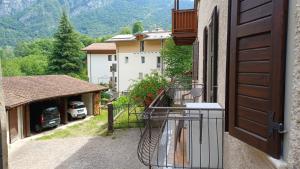 a balcony of a building with a car parked in a garage at Appartamento Felis in Molina di Ledro