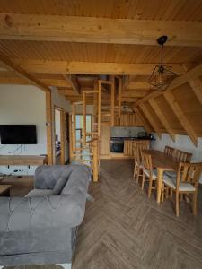 a living room with a couch and a table at Vlasic Odmor - Villa Ajla in Vlasic