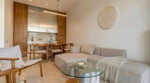 a living room with a couch and a table at Surfside Uluwatu Resort in Uluwatu