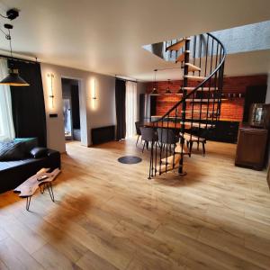 a living room with a spiral staircase and a table at LoftLove Lubianka in Starachowice +31 photos