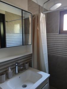 a bathroom with a sink and a mirror at Sofija apartments in Gevgelija +9 photos