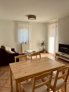 a living room with a table and a couch at Al Monte Zelo in Agordo +19 photos