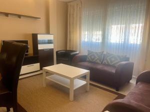 a living room with a couch and a coffee table at Viviendas Uso Turístico Arzúa in Arzúa