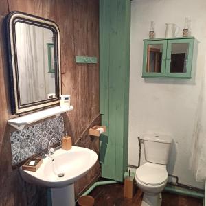 a bathroom with a sink and a toilet and a mirror at La Maison des 2L in Saint-Médard +15 photos