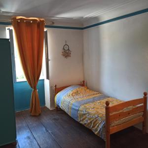 a bedroom with a bed and a window at La Maison des 2L in Saint-Médard