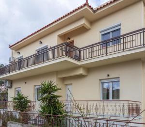a building with a balcony on it at Morpheas Apartment in Central Myrina in Myrina