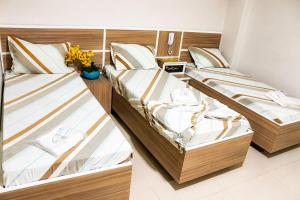 two twin beds in a room with at GM Hotel SP in Utinga +10 photos