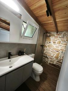 a bathroom with a toilet and a sink and a window at KONSTANTINOS Luxury Living in Ofrínion +48 photos