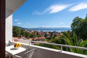a balcony with a table and chairs and a view at Villa Lili in Lovran