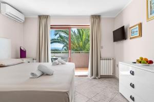 a bedroom with a bed and a window with a view at Villa Lili in Lovran