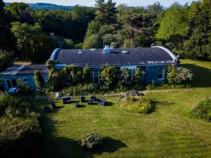 an aerial view of a blue house in a field at Shannon River House & Gardens in Limerick