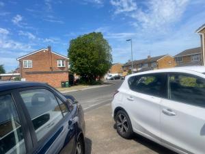two cars parked on the side of a street at Room Younis in Tilehurst