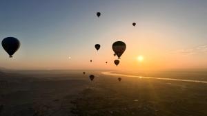 a group of hot air balloons flying in the sky at Jessica's House in Luxor