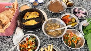 a table with many different dishes of food on it at Jessica's House in Luxor +40 photos