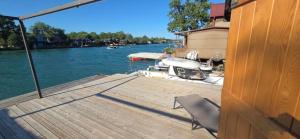 a wooden dock with a boat in the water at Sunshine House Ada Bojana in Ulcinj