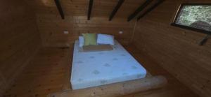 a bed in a wooden room with a window at Sunshine House Ada Bojana in Ulcinj +7 photos