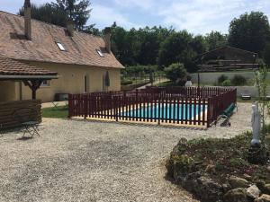 a wooden fence in front of a house at La maison du bonheur in Milhac