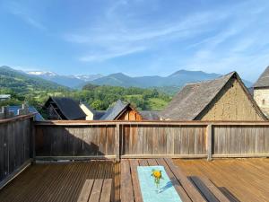 a wooden deck with a view of mountains at Le Refuge du Cap in Cescau
